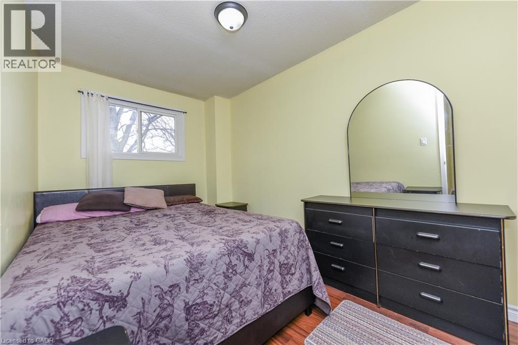 Bedroom featuring wood finished floors and a textured ceiling - 85 Enmount Drive, Brampton, ON - Indoor Photo Showing Bedroom