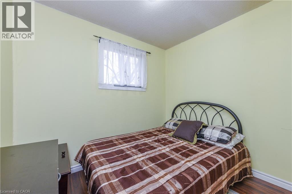 Bedroom featuring dark wood finished floors and a textured ceiling - 85 Enmount Drive, Brampton, ON - Indoor Photo Showing Bedroom
