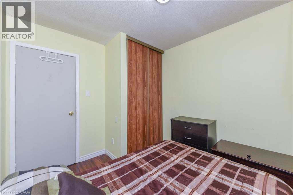 Unfurnished bedroom featuring wood finished floors, a closet, and a textured ceiling - 85 Enmount Drive, Brampton, ON - Indoor Photo Showing Bedroom