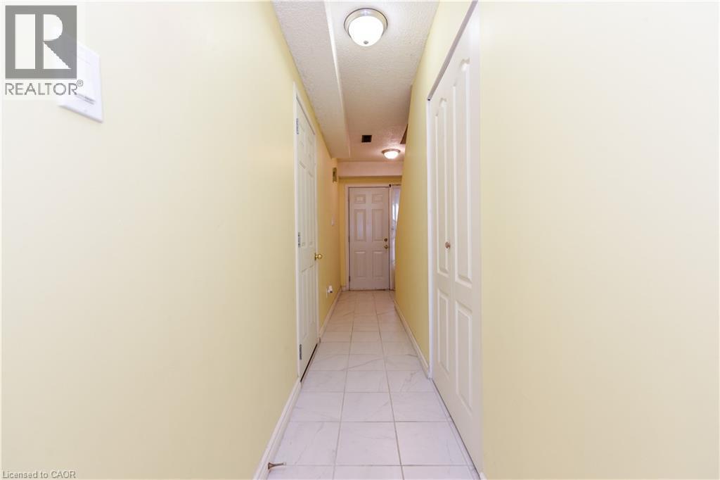 Hallway with baseboards and light tile patterned flooring - 85 Enmount Drive, Brampton, ON - Indoor Photo Showing Other Room