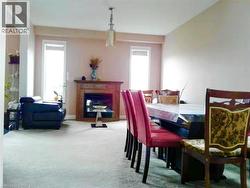 Carpeted dining room featuring a fireplace -