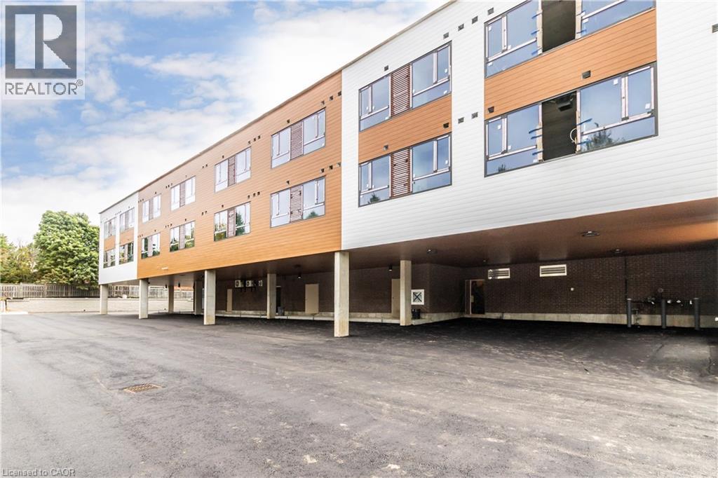 View of apartment building / complex with covered parking - 580 Coldstream Drive Unit# 212, Waterloo, ON - Outdoor