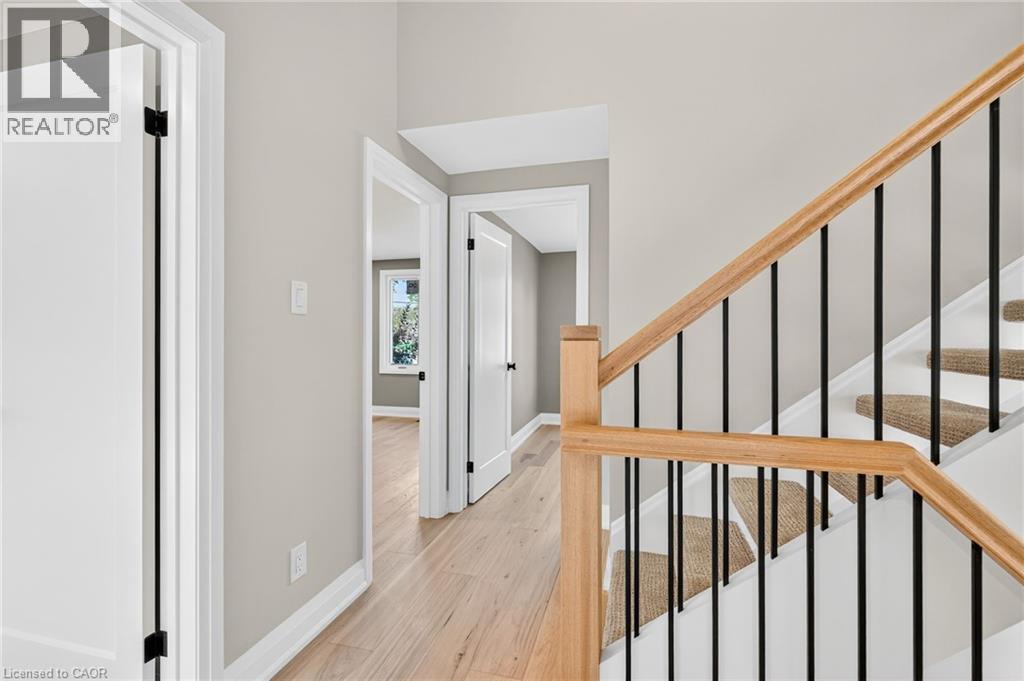 Stairs with wood finished floors and baseboards - 4006 Flemish Drive, Burlington, ON - Indoor Photo Showing Other Room