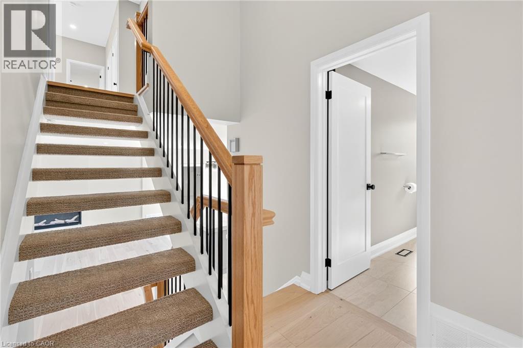 Staircase with baseboards and wood finished floors - 4006 Flemish Drive, Burlington, ON - Indoor Photo Showing Other Room