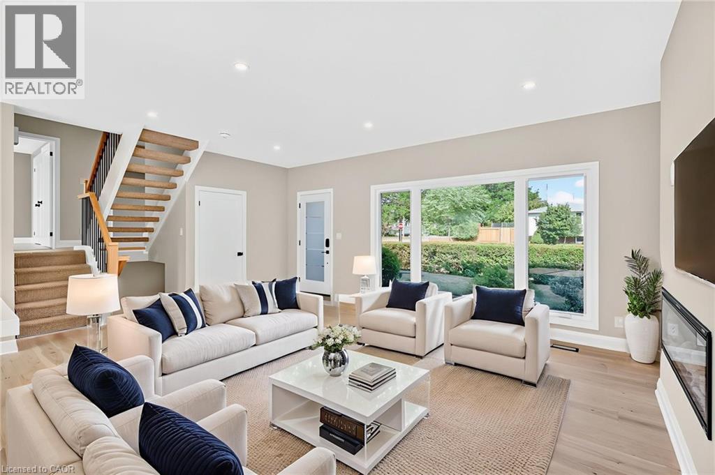 Living room with stairway, recessed lighting, and light wood-style floors - 4006 Flemish Drive, Burlington, ON - Indoor Photo Showing Living Room