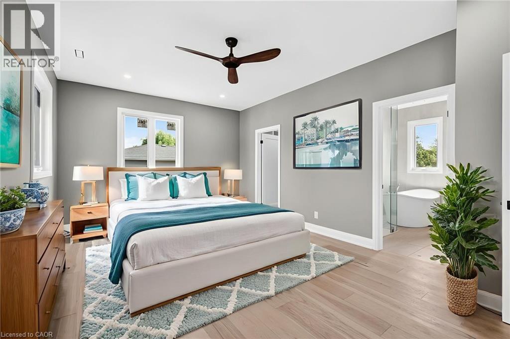 Bedroom with light wood-style flooring, ceiling fan, multiple windows, and recessed lighting - 4006 Flemish Drive, Burlington, ON - Indoor Photo Showing Bedroom