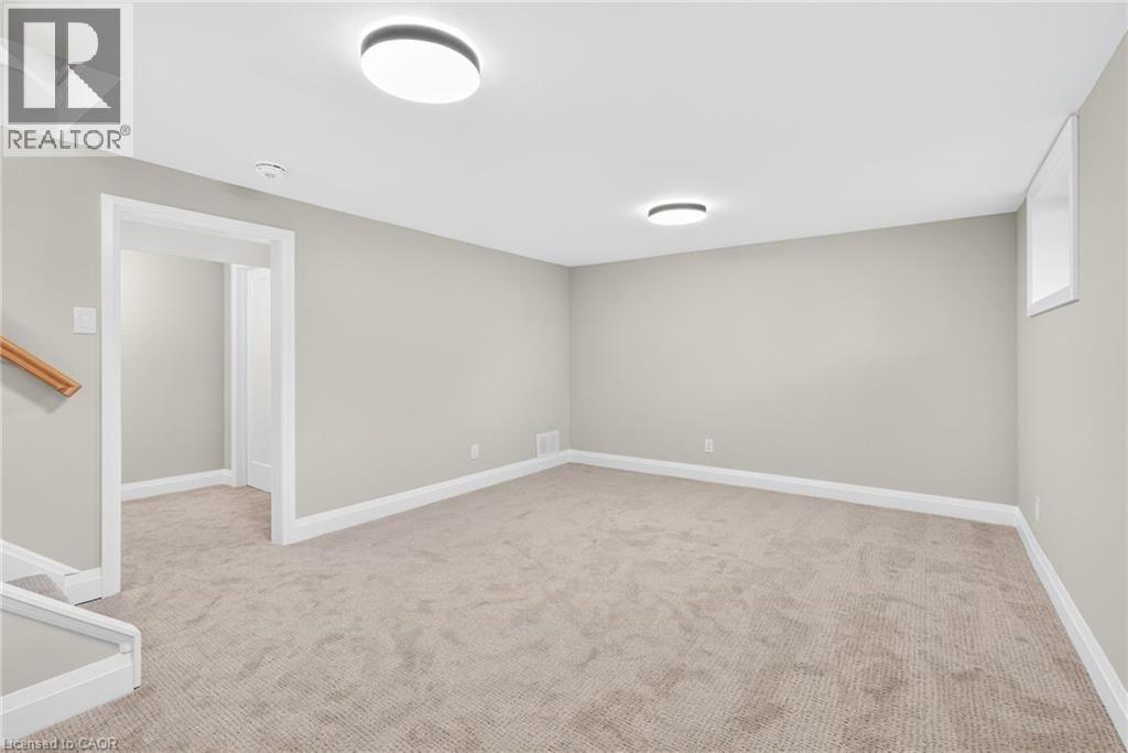 Basement with light carpet and baseboards - 4006 Flemish Drive, Burlington, ON - Indoor Photo Showing Other Room