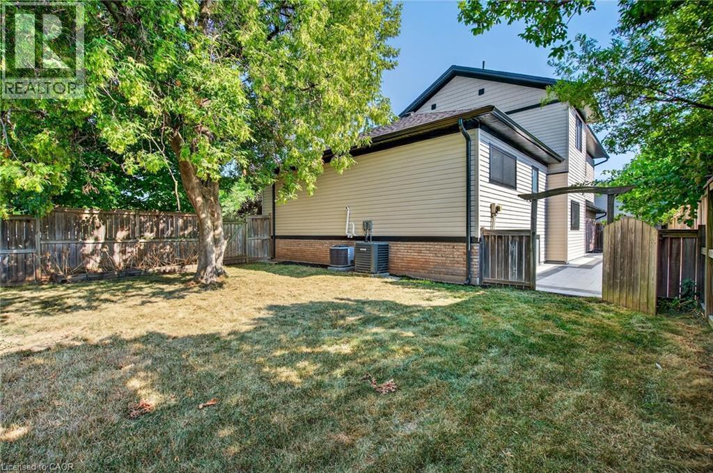 View of side of home with a fenced backyard and a cooling unit - 4006 Flemish Drive, Burlington, ON - Outdoor