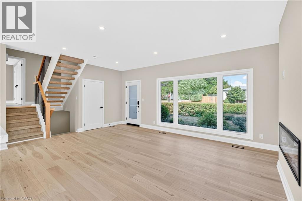 Unfurnished living room featuring stairs, recessed lighting, and light wood-style floors - 4006 Flemish Drive, Burlington, ON - Indoor