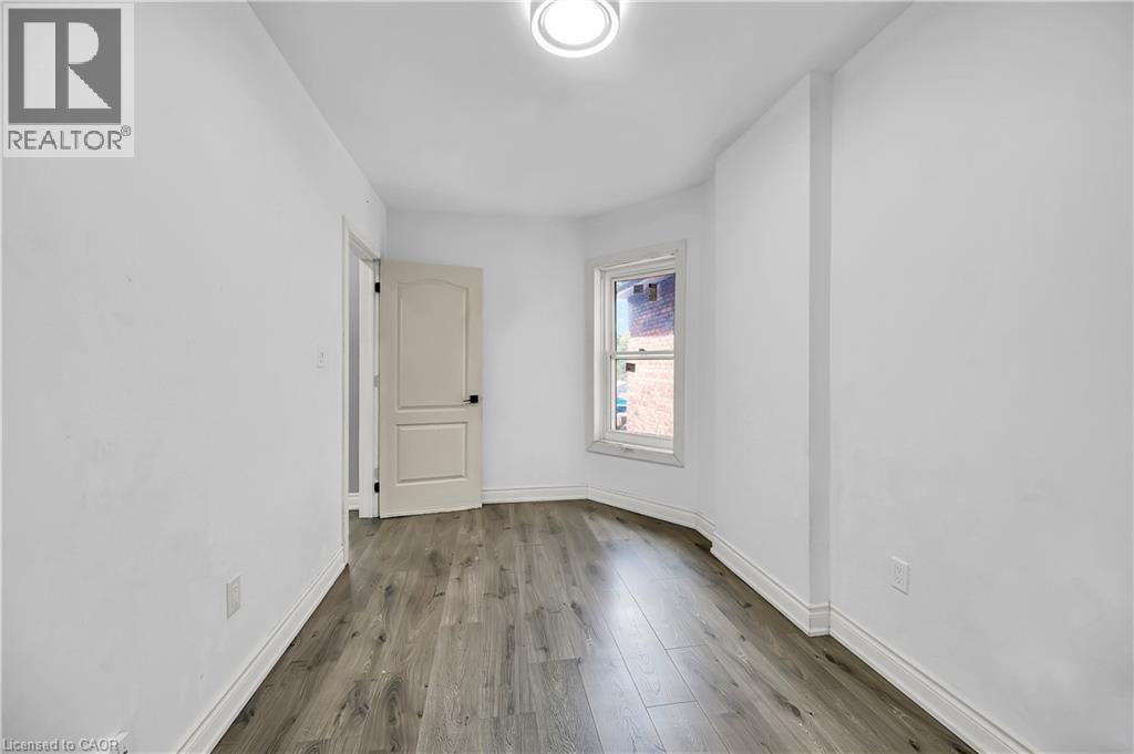 Spare room with wood finished floors and baseboards - 334 Cannon Street E, Hamilton, ON - Indoor Photo Showing Other Room