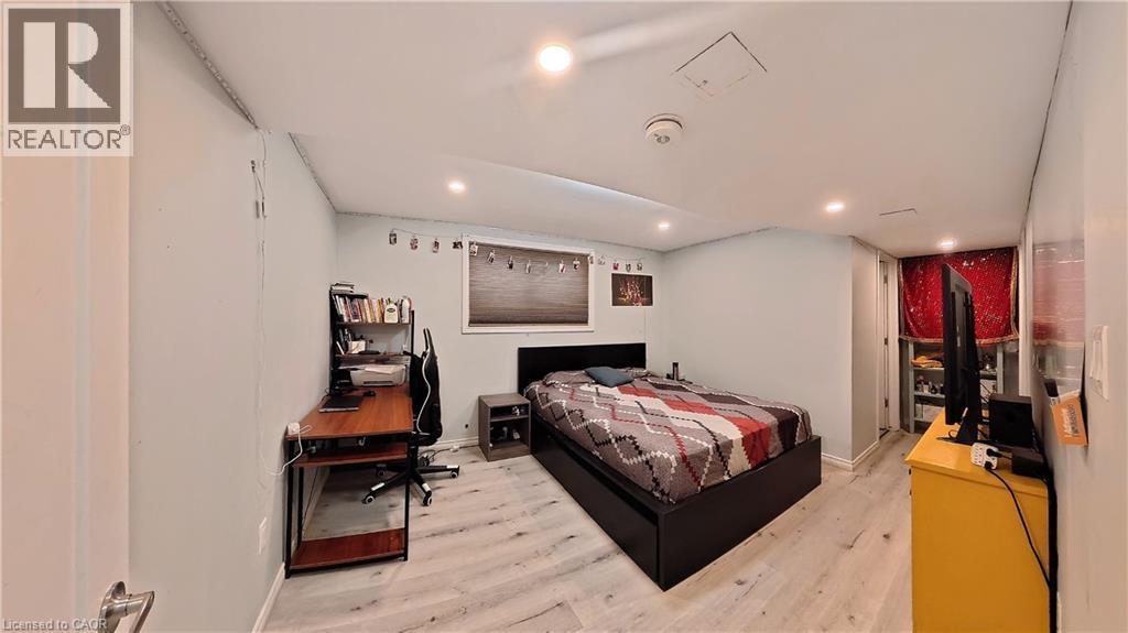 Bedroom with light wood finished floors and an office area - 61 Bosworth Crescent, Kitchener, ON - Indoor Photo Showing Other Room