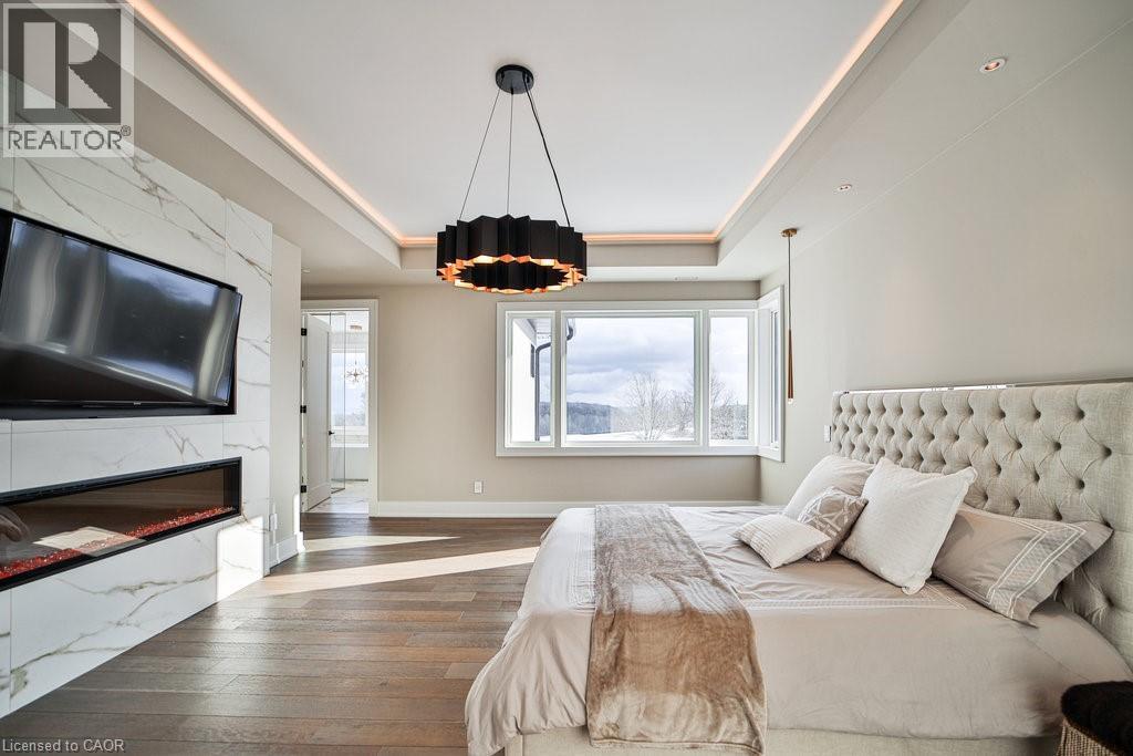 2284 Sideroad 1, Burlington, ON - Indoor Photo Showing Bedroom With Fireplace