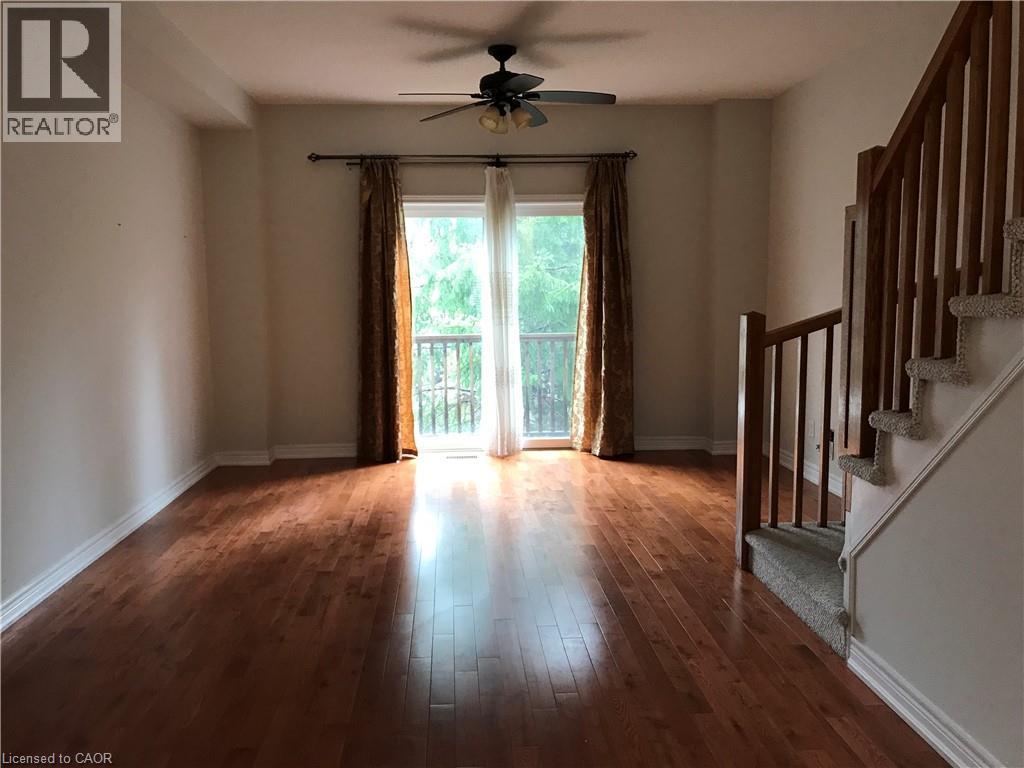 Spare room with wood finished floors, ceiling fan, and stairway - 4294 Ingram Common, Burlington, ON - Indoor Photo Showing Other Room