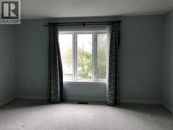 Carpeted spare room featuring a textured ceiling -
