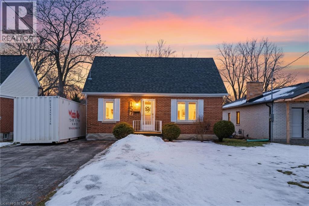 New england style home featuring brick siding, roof with shingles, and a chimney - 157 Bridgeport Road E, Waterloo, ON - Outdoor
