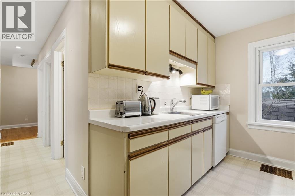 Kitchen featuring light flooring, light countertops, cream cabinets, white appliances, and recessed lighting - 157 Bridgeport Road E, Waterloo, ON - Indoor Photo Showing Kitchen