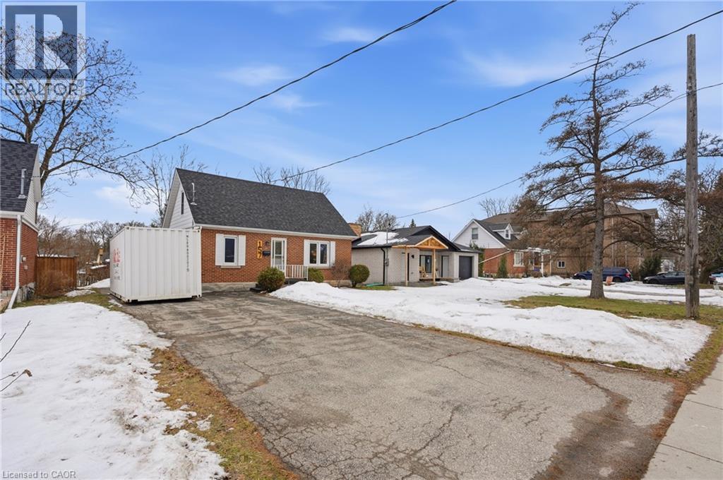 View of front facade featuring brick siding and a shingled roof - 157 Bridgeport Road E, Waterloo, ON - Outdoor