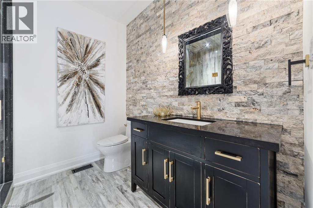Bathroom featuring walk-in shower with modern tile, rain head, stand alone vanity and toilet - 515 Hamilton Drive, Ancaster, ON - Indoor Photo Showing Bathroom