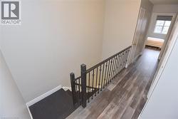 Staircase featuring wood finished floors -