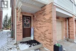 View of exterior entry with brick siding -