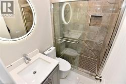 Bathroom featuring vanity, a stall shower, and marble finish flooring -