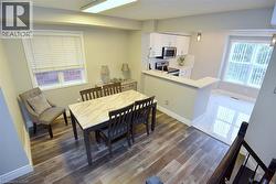 Dining area with light wood-style floors and baseboards -