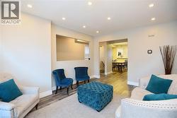 Living room featuring recessed lighting, wood finished floors, and a textured ceiling -