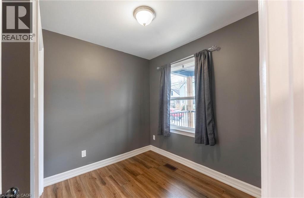 Unfurnished room with baseboards and wood finished floors - 140 Royal Avenue, Hamilton, ON - Indoor Photo Showing Other Room