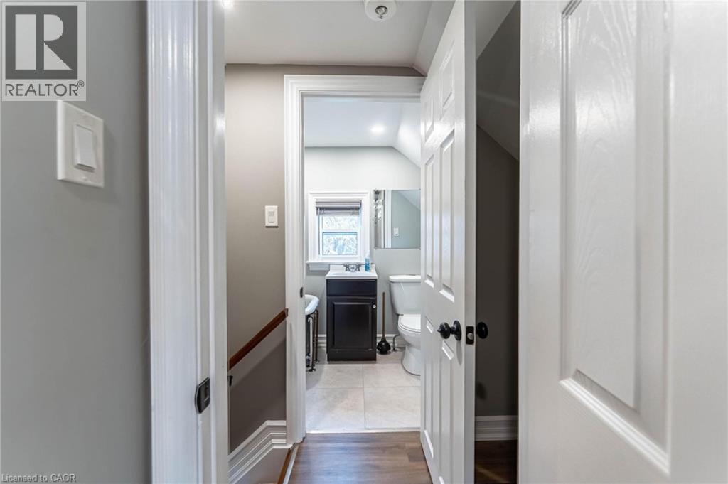 Bathroom with vanity, wood finished floors, and lofted ceiling - 140 Royal Avenue, Hamilton, ON - Indoor Photo Showing Other Room