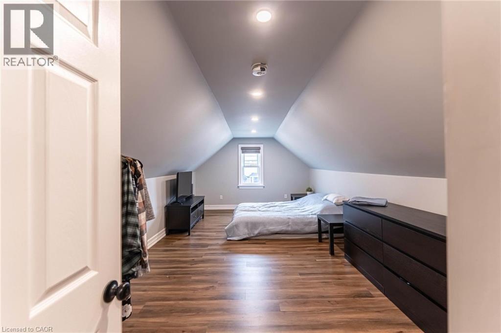 Bedroom featuring lofted ceiling, dark wood-style flooring, and recessed lighting - 140 Royal Avenue, Hamilton, ON - Indoor Photo Showing Bedroom
