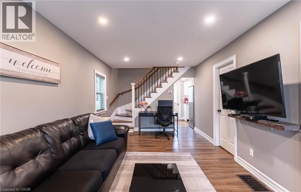 Living room with light wood-style floors, stairs, a desk, and recessed lighting - 140 Royal Avenue, Hamilton, ON - Indoor Photo Showing Living Room