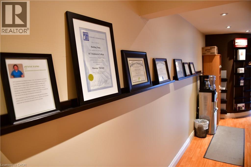 Corridor featuring light wood finished floors and recessed lighting - 265 Queen Street S, Mississauga, ON