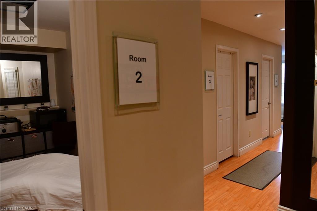 Hallway featuring light wood-type flooring and recessed lighting - 265 Queen Street S, Mississauga, ON