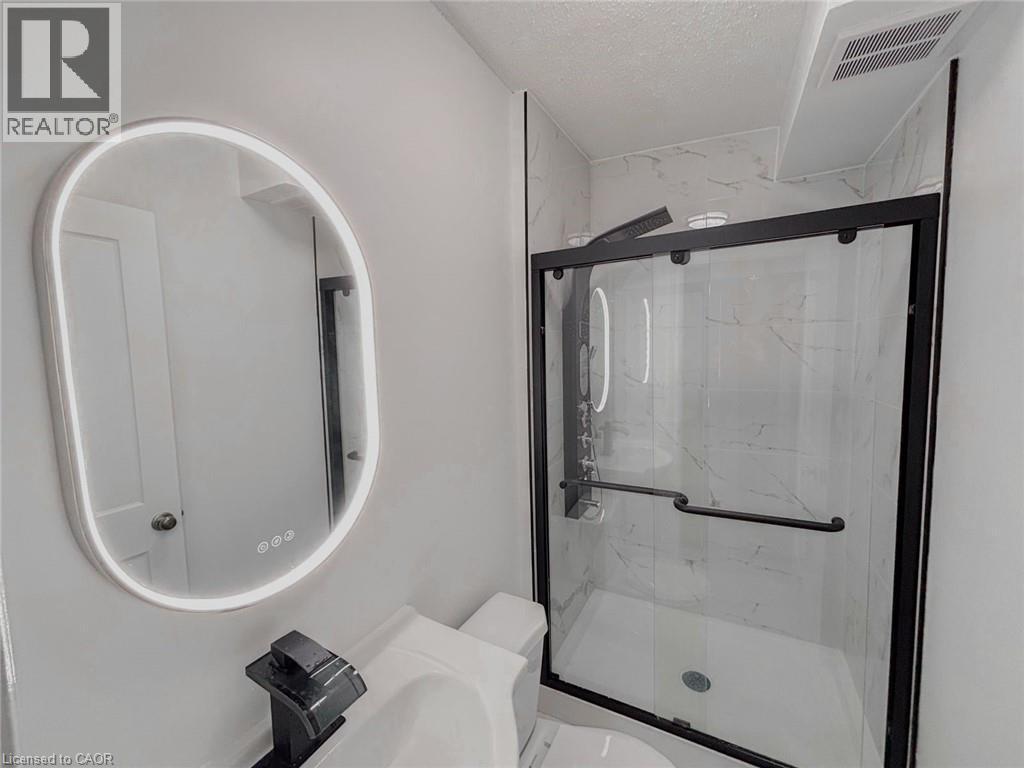 Full bath with a marble finish shower, a textured ceiling, and vanity - 1949 Old Mill Road, Kitchener, ON - Indoor Photo Showing Bathroom
