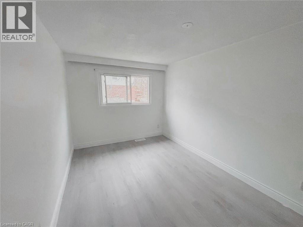 Unfurnished room featuring baseboards and light wood-style floors - 1949 Old Mill Road, Kitchener, ON - Indoor Photo Showing Other Room