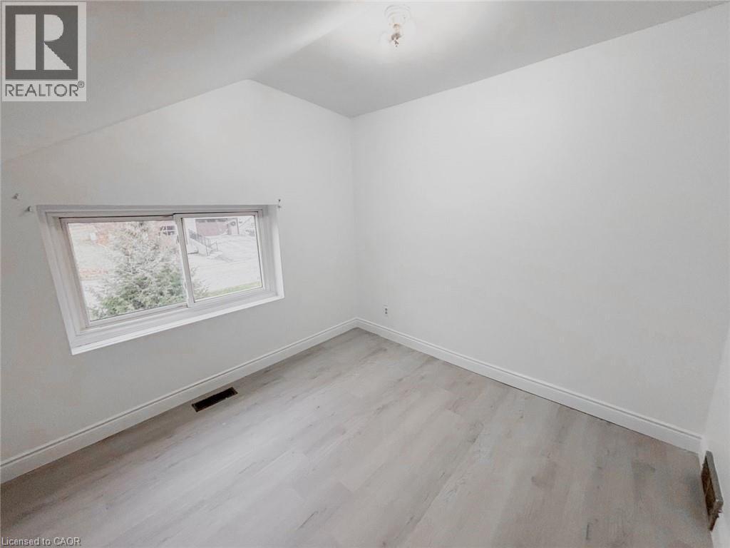 Additional living space with lofted ceiling and light wood-type flooring - 1949 Old Mill Road, Kitchener, ON - Indoor Photo Showing Other Room