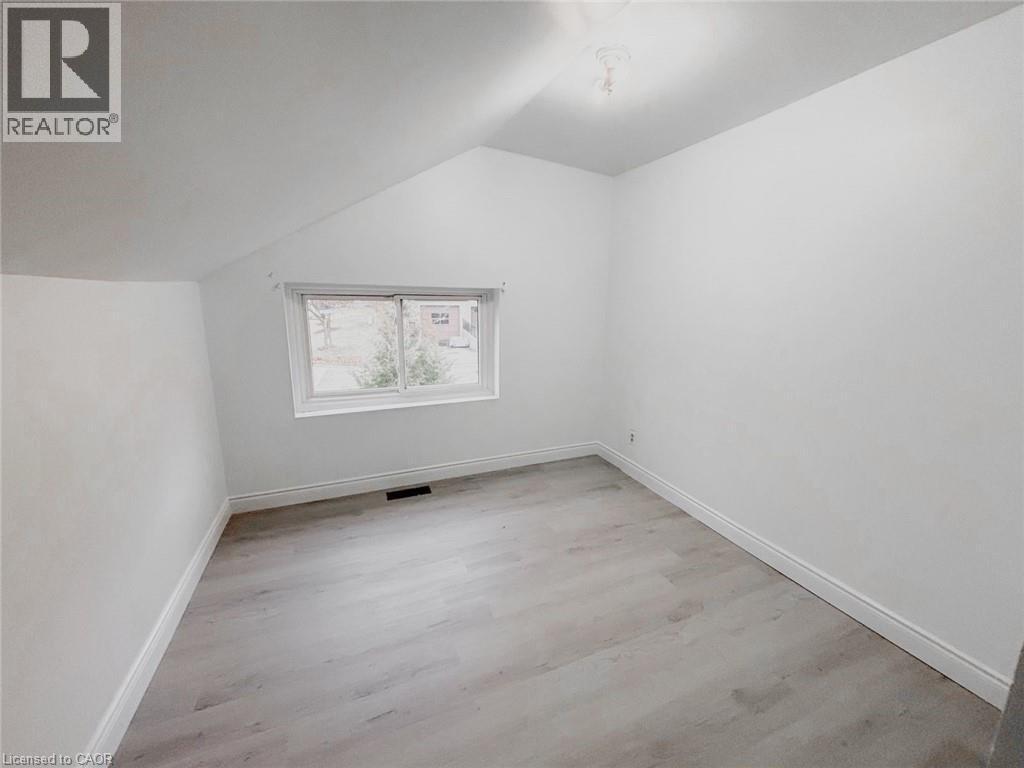 Additional living space with lofted ceiling and light wood-style flooring - 1949 Old Mill Road, Kitchener, ON - Indoor Photo Showing Other Room