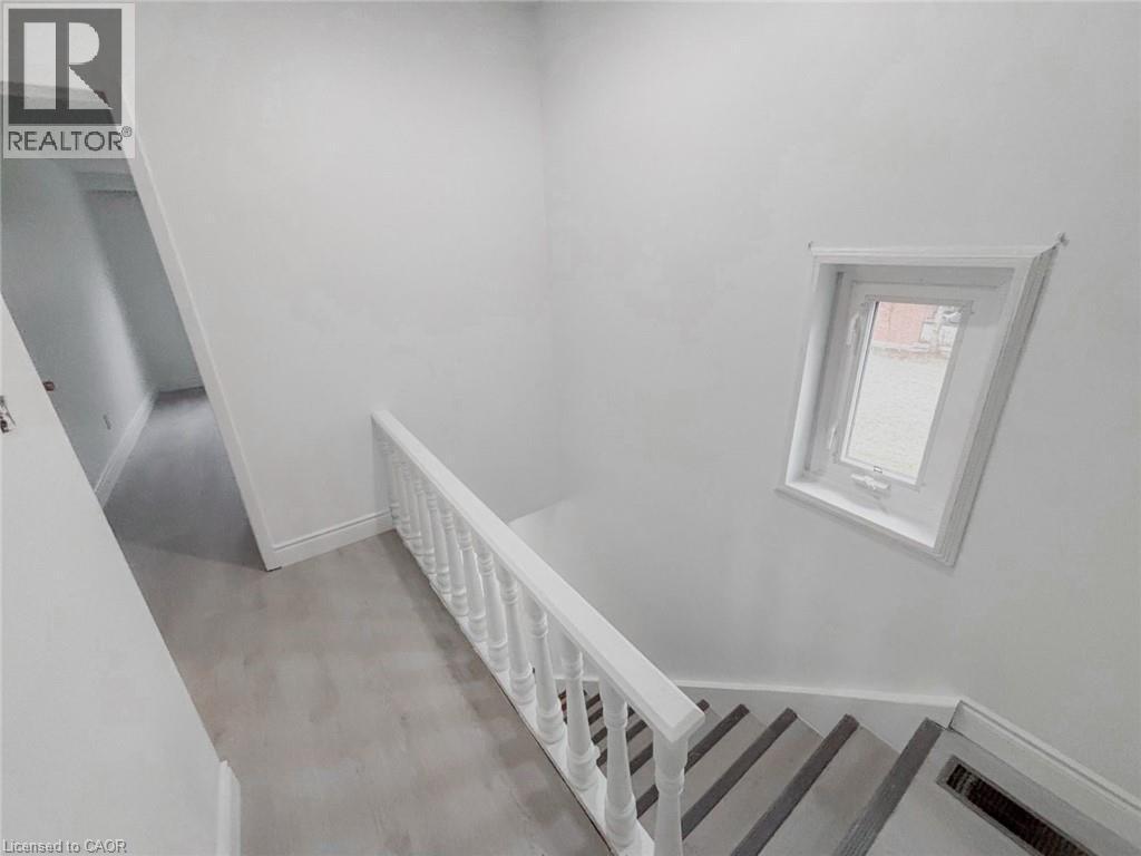 Stairway with baseboards and wood finished floors - 1949 Old Mill Road, Kitchener, ON - Indoor Photo Showing Other Room