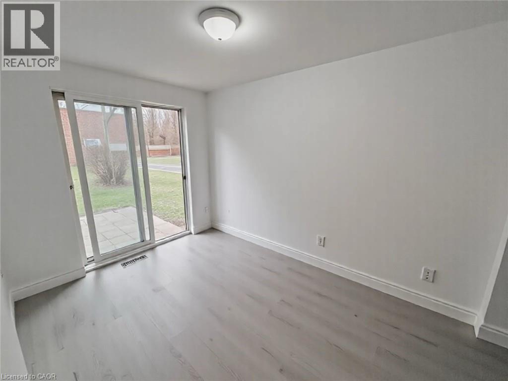 Unfurnished room with wood finished floors and baseboards - 1949 Old Mill Road, Kitchener, ON - Indoor Photo Showing Other Room