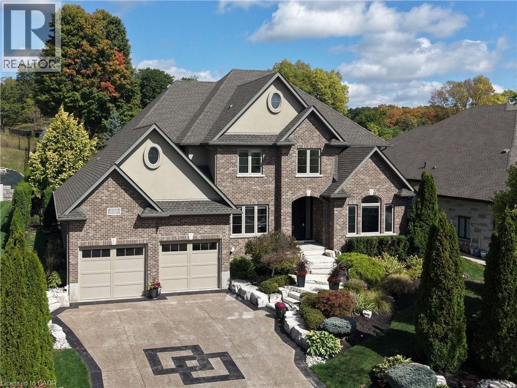 View of front of house with brick siding, concrete driveway, stucco siding, and a garage - 237 River Birch Street, Kitchener, ON - Outdoor With Facade