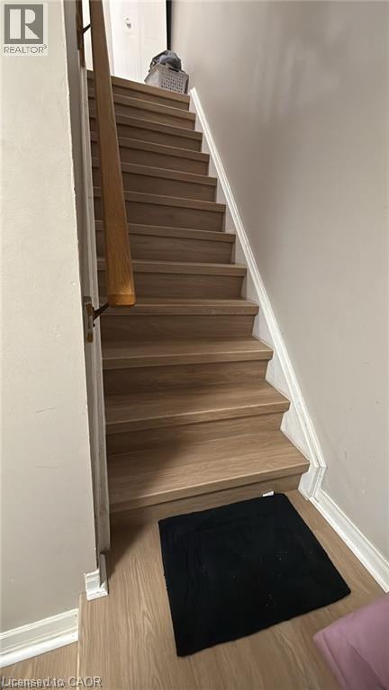 Stairway with baseboards and wood finished floors - 419 Downsview Place, Waterloo, ON - Indoor Photo Showing Other Room