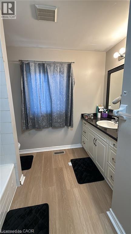 Full bathroom with vanity, light wood finished floors, and a bath - 419 Downsview Place, Waterloo, ON - Indoor Photo Showing Bathroom