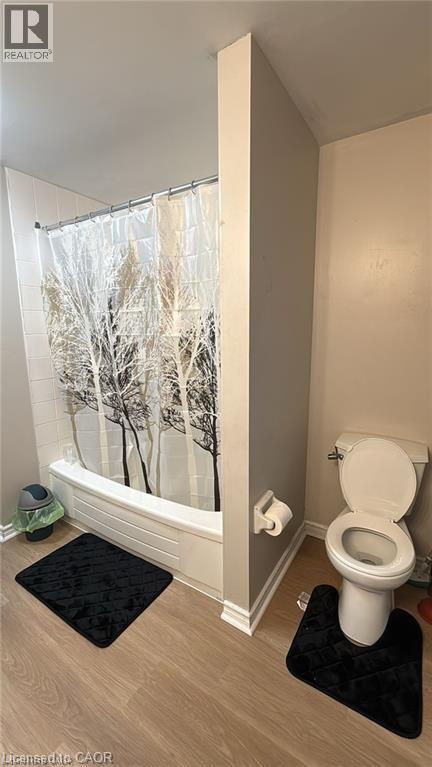 Full bathroom with shower / bath combo and wood finished floors - 419 Downsview Place, Waterloo, ON - Indoor Photo Showing Bathroom