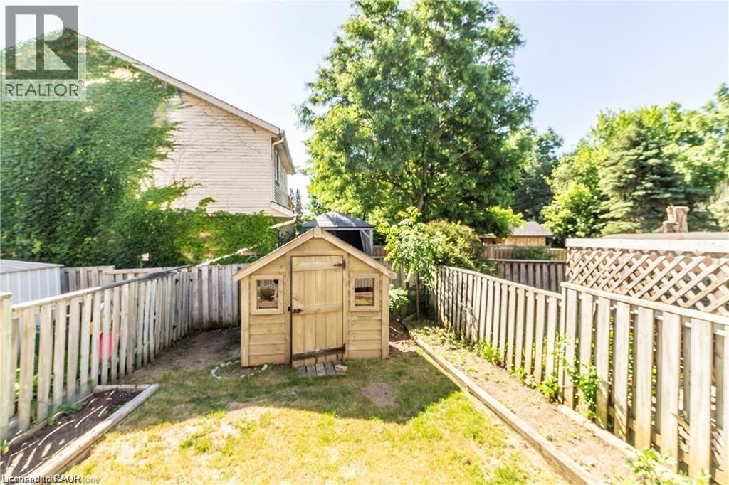 Fenced backyard featuring a storage unit - 419 Downsview Place, Waterloo, ON - Outdoor