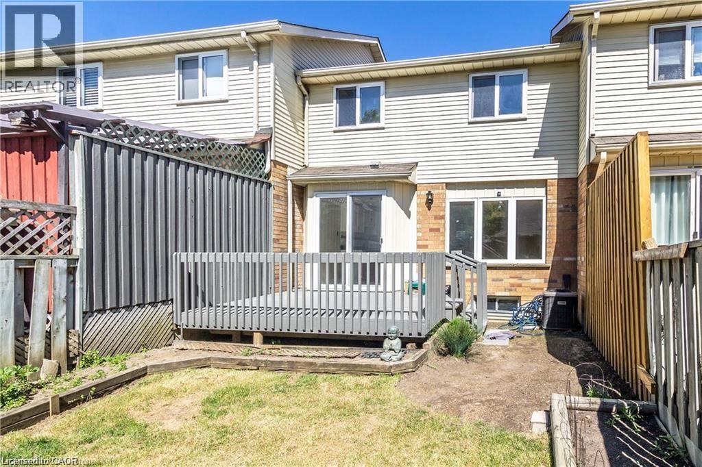 Rear view of house featuring a deck and brick siding - 419 Downsview Place, Waterloo, ON - Outdoor With Deck Patio Veranda With Exterior