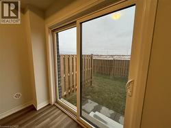 Entryway with wood finished floors and baseboards -