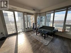 Sunroom with wood-type flooring and a city view -