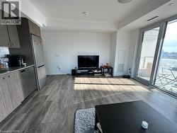 Living room with dark wood-style floors and floor to ceiling windows -