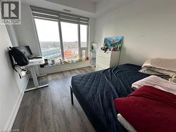 Bedroom featuring wood finished floors and baseboards -