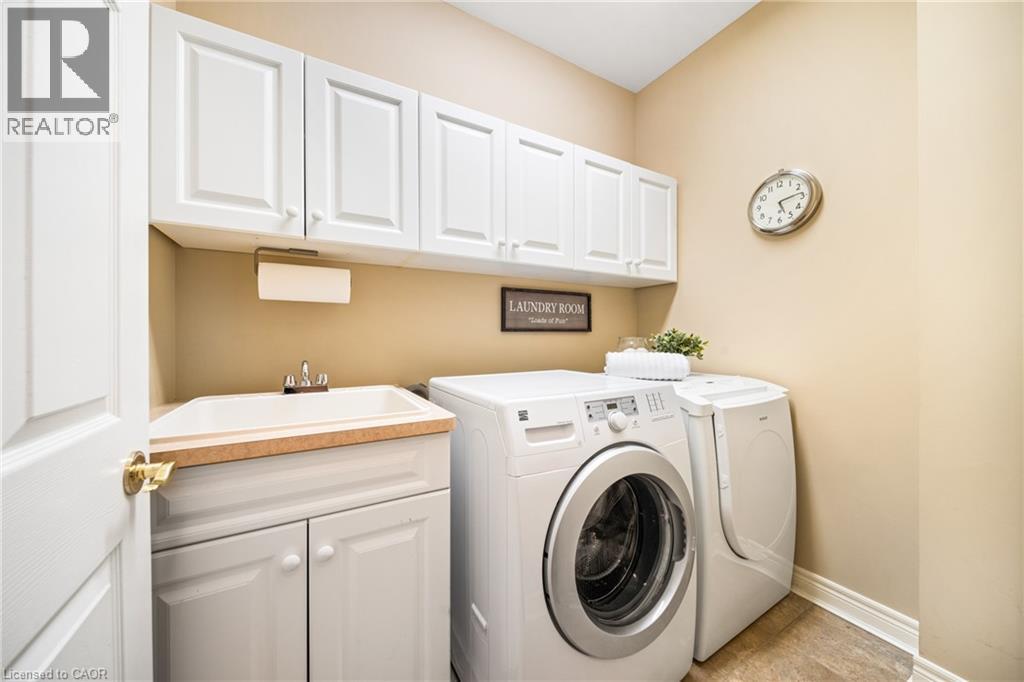 Washroom featuring washer and dryer and cabinet space - 4165 Stonebridge Crescent, Burlington, ON - Indoor Photo Showing Laundry Room